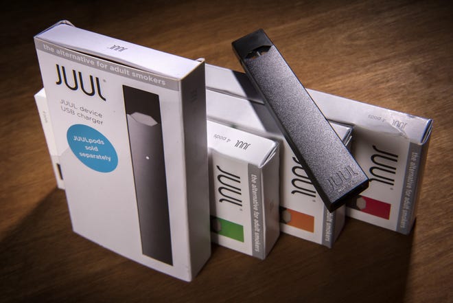 A Juul vaping system with accessory pods in various flavors. [Washington Post photo by Bill O'Leary]