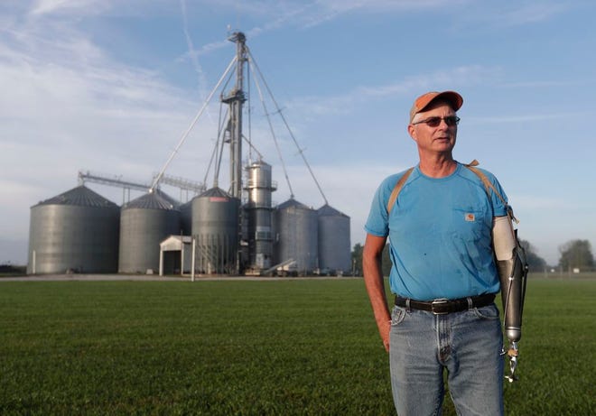 Jack Maloney poses in front of the grain bins on his Little Ireland Farms in Brownsburg, Ind. Maloney, who farms about 2,000 acres in Hendricks Count, said the aid for farmers is "a nice gesture" but what farmers really want is free trade, not government handouts. American farmers will soon begin getting checks from the government as part of a billion-dollar bailout to help those experiencing financial strain from President Donald Trump's trade disputes with China.