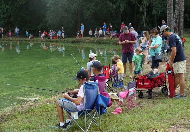 Some of the hundreds who lined the banks of the DNR ponds at the Richmond Hill Fish Hatchery for the Richmond Hill Exchange Club's annual Kids Fishing Derby Sept. 22. [Jamie Parker/Bryan County Now]