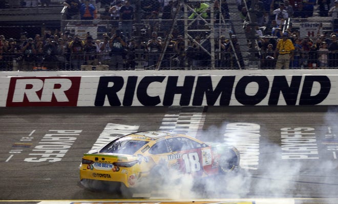 Kyle Busch (18) does a burnout as he celebrates winning the NASCAR Cup Series race at Richmond Raceway in Richmond, Va. on Saturday. [STEVE HELBER/THE ASSOCIATED PRESS]