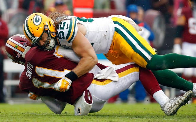 Green Bay Packers linebacker Clay Matthews (52) hits Washington Redskins quarterback Alex Smith (11) during the second half of an NFL football game, Sunday, Sept. 23, 2018 in Landover, Md. (AP Photo/Alex Brandon)