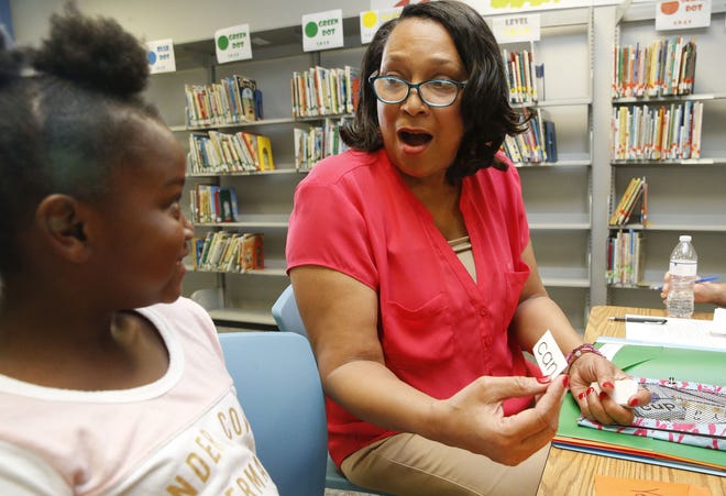 Makayla Morrow reads a word on a flash card with Pam Pruitt who feigns surprise as they work together in the Book Buddies program at Central Elementary School in their temporary location at Stillman Heights Thursday, Sept. 20, 2018. The program is part of the Tuscaloosa City Schools system's effort to get every child reading at grade level by the third grade. [Staff Photo/Gary Cosby Jr.]
