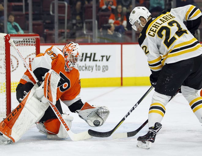 The Bruins' Peter Cehlarik is about to score Boston's first goal on the Flyers' Brian Elliott during the first period of Monday night's preseason game. [TOM MIHALEK / THE ASSOCIATED PRESS]