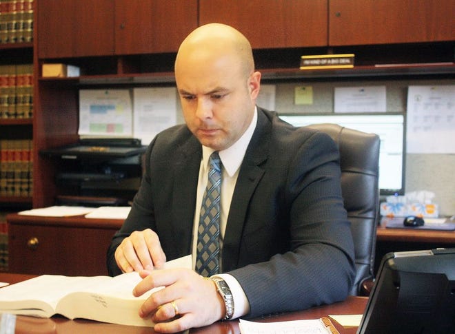 State's Attorney Randy Yedinak reviews statutes that concern specialty courts in Illinois. The state's attorney's office is a big part of the functioning of drug courts.