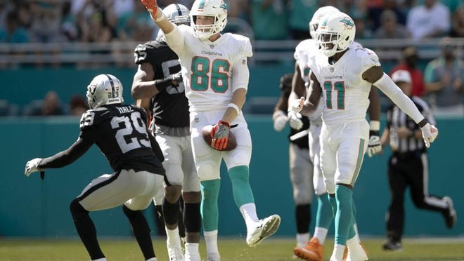 Miami Dolphins tight end Mike Gesicki signals a first down after making a catch against the Oakland Raiders at Hard Rock Stadium on Sunday.