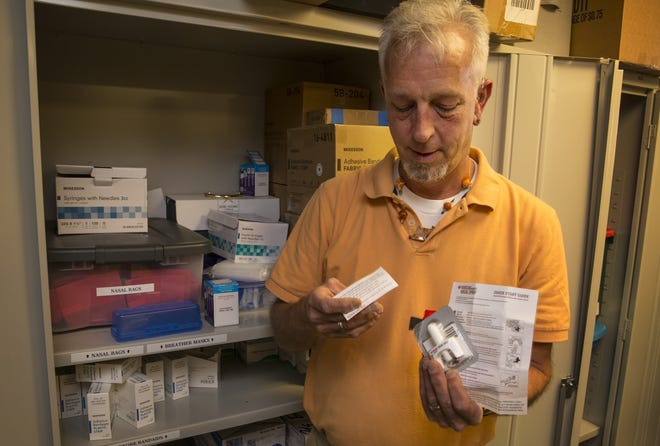 Prevention and Education Manager Dane Zahner for HIV Alliance pulls a Narcan nasal spray kit from supplies at the agency's Eugene offices. The kits have been credited with saving several people who have reportedly suffered overdoses this week. [Chris Pietsch/The Register-Guard] - registerguard.com