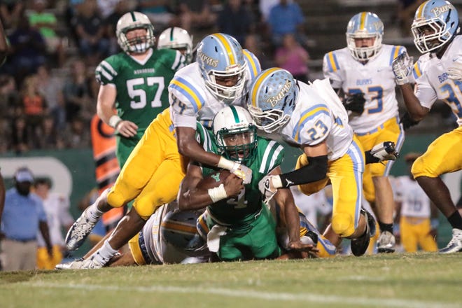 Two Burns defenders converge on an Ashbrook runner during last week's game in Gastonia. [Bill Bostick/Special to The Gazette]