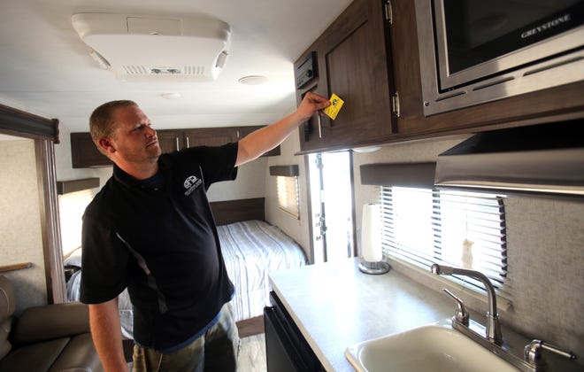 Owner Jimmy Boheler prepares a camper for the next guest at KM Camping Rentals. [Brittany Randolph/The Star]