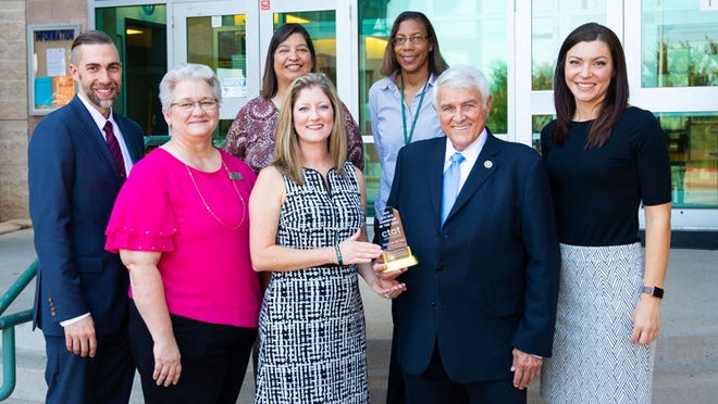 U.S. Rep. John Carter received the Career and Technical Association of Texas’ Champion of the Year Award. Round Rock school district staff, pictured standing with Carter, nominated him for the award. Courtesy photo