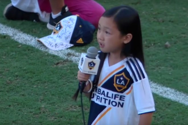 This image from a YouTube video shows Malea Emma Tjandrawidjaja performing the "Star-Spangled Banner" Sunday at StubHub Center in Los Angeles. [MLS via YouTube]