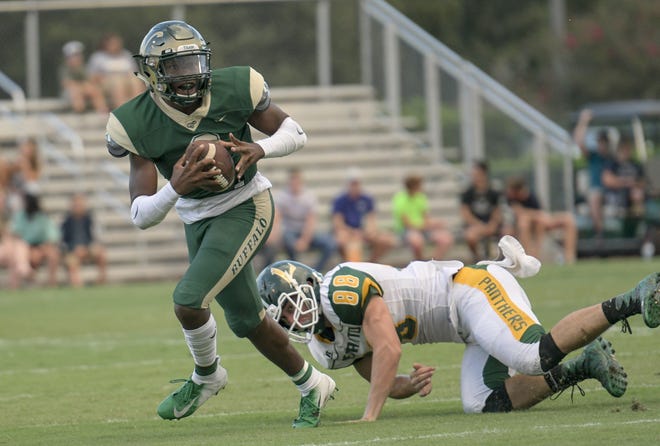 The Villages' Mac Harris (2) evades a defender as he looks for an open receiver during a game against Lecanto on Friday in The Villages. The Buffalo are currently ranked second in Class 4A-Region 2. [PAUL RYAN / CORRESPONDENT]
