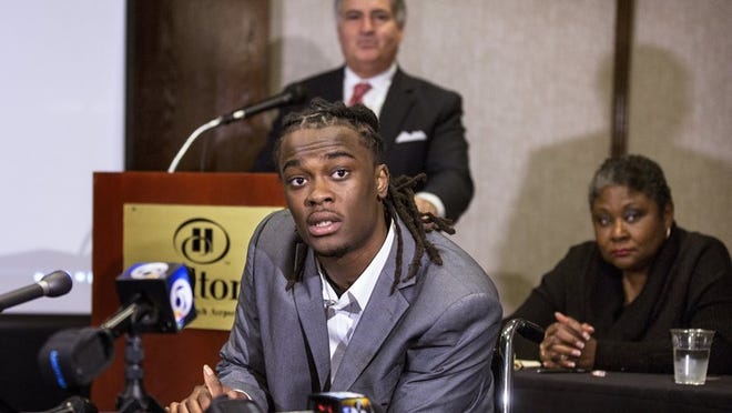 Dontrell Stephens, center speaks to the media, with his attorney Jack Scarola, behind him and Evett Simmons, his court appointed guardian, right, during a press conference at the Hilton Palm Beach Airport, February 11, 2016, in West Palm Beach. (Bill Ingram / The Palm Beach Post)