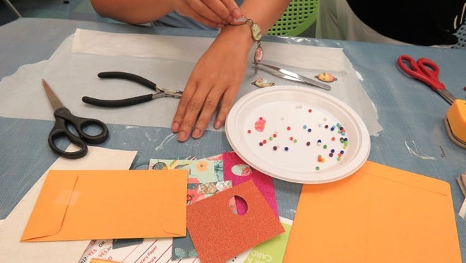 Participants make jewelry during a class at the new Studio 411 space at Mandel Public Library. Photo courtesy of Mandel Public Library