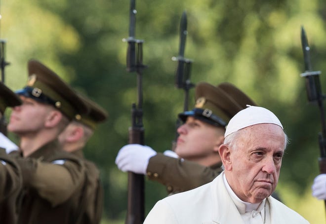 Pope Francis reviews an honor guard during a welcome ceremony at the Kadriorg Palace in Tallinn, Estonia, Tuesday, Sept. 25, 2018. Pope Francis arrived in Estonia for a one-day visit Tuesday.