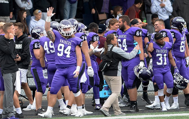 Mount Union defender Ian Meacham ways a final goodbye to John Carroll near the end a of hard-fought, and at times chippy, game won by the Purple Raiders, Sept. 22, 2018. (CantonRep.com / Ray Stewart)