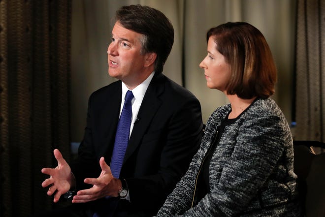 Brett Kavanaugh, with his wife Ashley Estes Kavanaugh, answers questions during a FOX News interview, Monday, Sept. 24, 2018, in Washington, about allegations of sexual misconduct against the Supreme Court nominee. (AP Photo/Jacquelyn Martin)