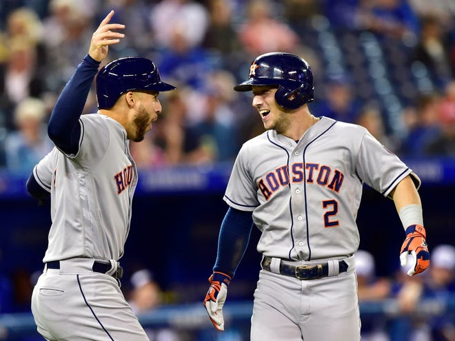 Houston Astros' Alex Bregman (2) celebrates his two-run home run with George Springer (4) during the first inning of a baseball game against the Toronto Blue Jays on Tuesday, Sept. 25, 2018, in Toronto. (Frank Gunn/The Canadian Press via AP)