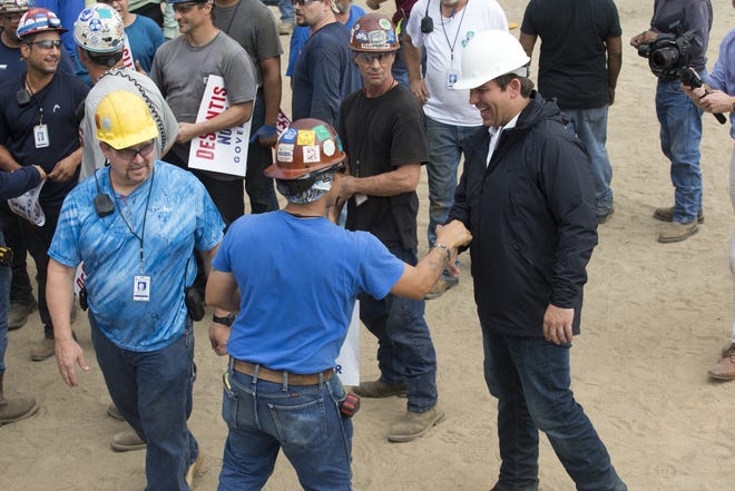 Republican candidate for governor Ron DeSantis, white hard hat at right, talks Tuesday with workers at Eastern Shipbuilding about his background, public safety and taxes. [JOSHUA BOUCHER/THE NEWS HERALD]