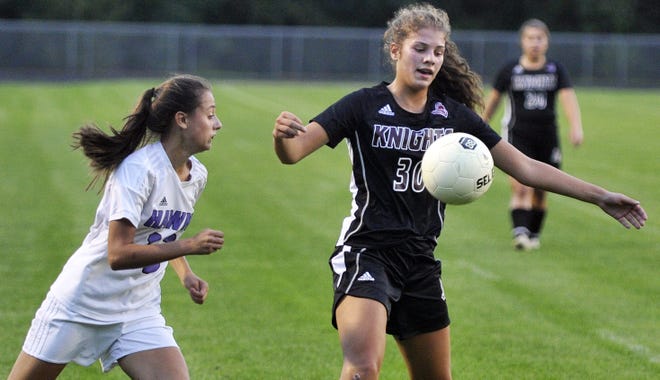 Noble's Olivia Howard, right, looks to win this ball from Marshwood's Carmela Kriz during Class A South action Wednesday in North Berwick, Maine. [John Huff/Fosters.com]