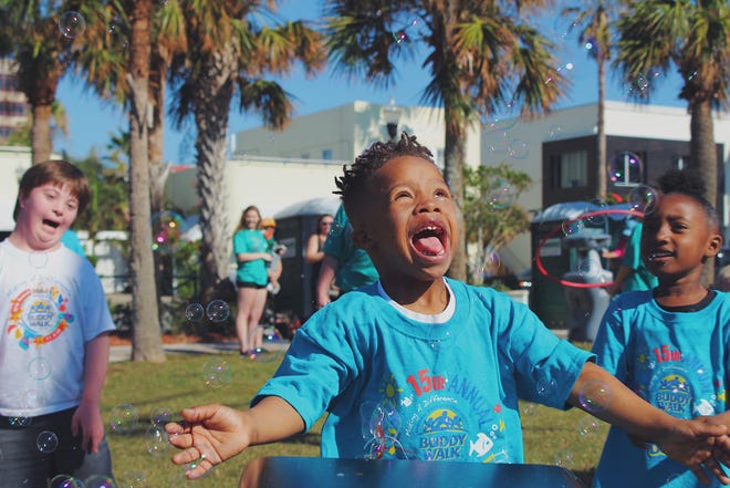 Several young buddies laugh with delight as bubbles float around them during the 2017 Buddy Walk. This year's event is scheduled for Saturday, Oct. 20 at the Sea Walk Pavilion in Jacksonville. [PHOTO COURTESY DOWN SYNDROME ASSOCIATION OF JACKSONVILLE]