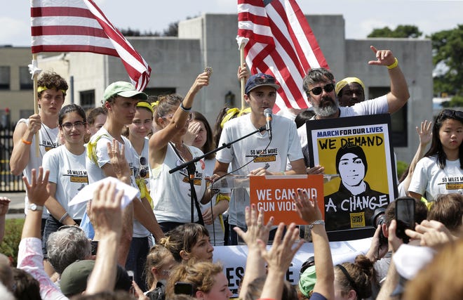 David Hogg, center, a survivor of the school shooting at Marjory Stoneman Douglas High School, in Parkland, addresses a rally in front of the headquarters of gun manufacturer Smith & Wesson in Springfield, Mass. The rally was held at the conclusion of a 50-mile march meant to call for gun law reforms in late August. [FILE/THE ASSOCIATED PRESS]