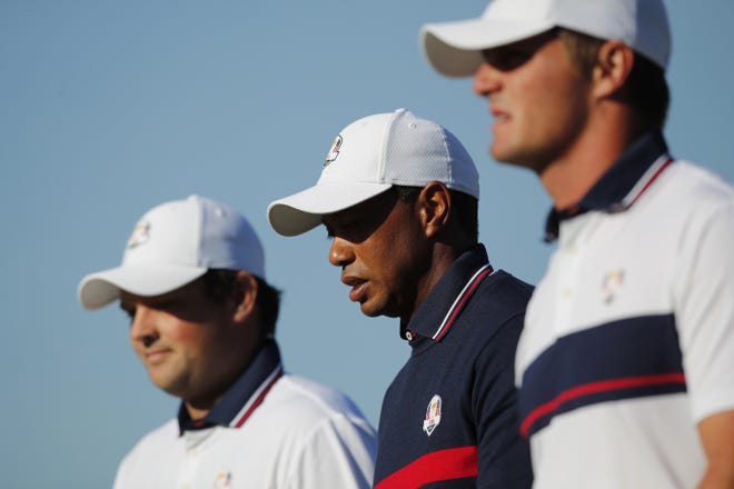 Tiger Woods with teammates Patrick Reed, left, and Bryson Dechambeau, right, during a Ryder Cup practice session in France Tuesday. [Francois Mori/Associated Press]