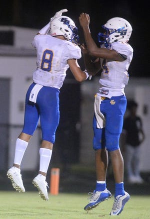 Eastern Guilford receiver Justin Matthews, left, and quarterback Kamel Smith celebrate after a touchdown.