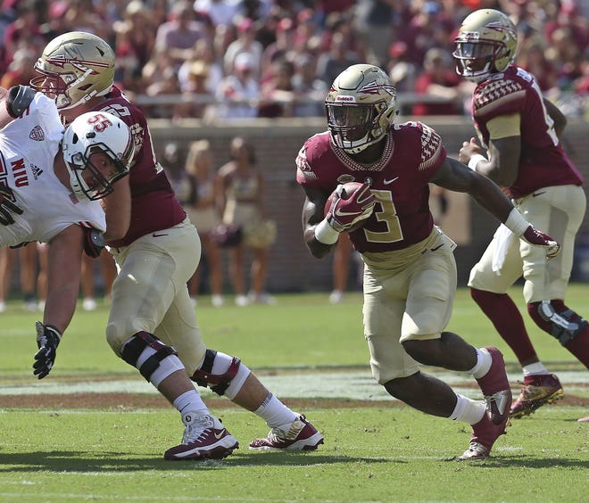 Florida State's Cam Akers cuts upfield on a running play against Northern Illinois' defense in the first quarter of an NCAA college football game Saturday in Tallahassee. [STEVE CANNON/AP PHOTO]