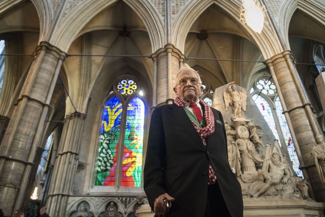 British artist David Hockney stands in front of The Queen's Window, a new stained glass window at Westminster Abbey, London. [Victoria Jones/Pool via AP]