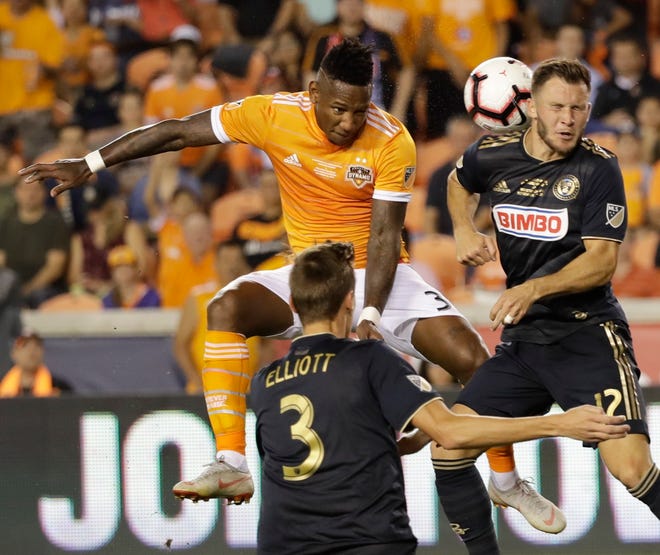 Houston Dynamo's Romell Quioto takes a shot against Philadelphia Union's Keegan Rosenberry during the second half of the U.S. Open Cup championship soccer match Wednesday. (AP Photo/David J. Phillip)