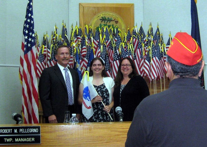 From left to right, Northampton supervisor Chairman Barry Moore, Kaitlin and Sue Reichert, sister and mother to Tyler Reichert, who was recognized with an Army flag Wednesday, Sept. 26, 2018. [Courtesy of Pete Palestina]