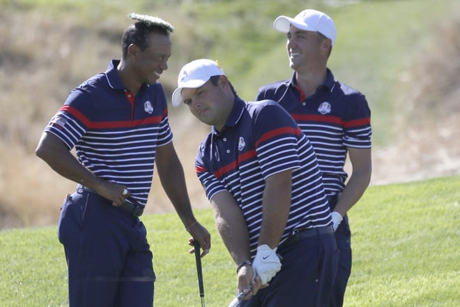 Tiger Woods of the U.S. places the cover of a water sprinkler on his head as he jokes with Patrick Reed, center, and Jordan Spieth, right, during a practice round of the Ryder Cup at Le Golf National in Saint-Quentin-en-Yvelines, outside Paris, France, on Thursday. [AP Photo/Francois Mori]