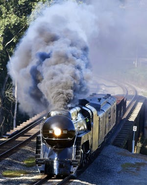 The Norfolk and Western J Class steam engine 611 crosses the Yadkin River on its return trip back to Roanoke, Virginia, early Wednesday morning. [David Yemm/Yemm Photography]