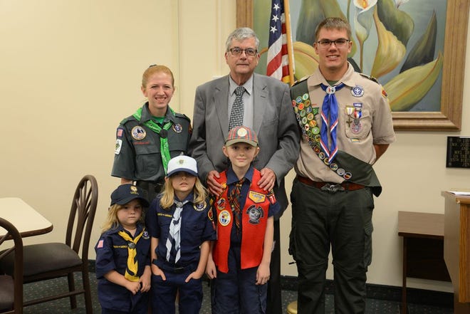 Judge Terrence P. Bronson stands between scouts Hillary Hemry and Luke Bilan, and in front of scouts Mackenzie, Zoe and Zach Krabach at Tuesday's first annual Distinguished Citizen Dinner. Bronson was honored for his 15 years of service to the Boy Scouts of America (BSA) and a 20-year career on the bench. (Monroe News photo by BLAKE BACHO)
