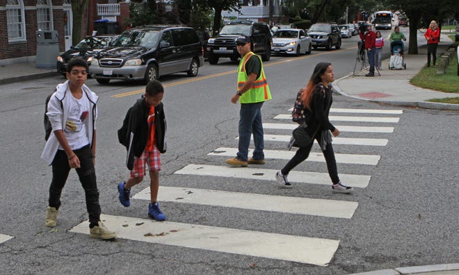 Providence---Sept.27, 2018--- Students head to Esek Hopkins Middle School Thursday morning. Bus monitors who would normally ride to school with students now have been redeployed to assist at the school. A Providence police officer will be stationed at each of the public schools, and other police will be patrolling busy routes to ensure the safety of all walkers. [The Providence Journal/Steve Szydlowski]