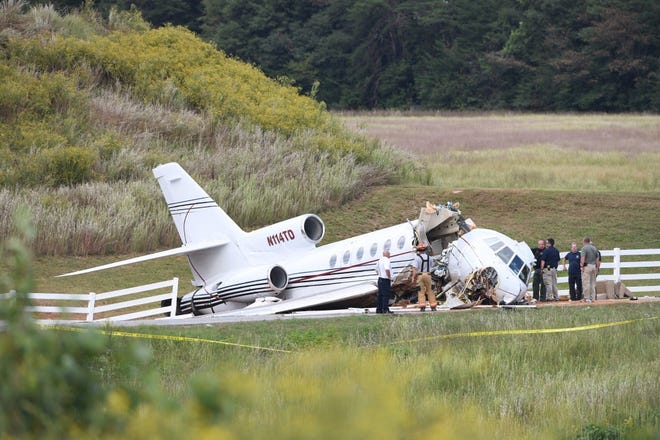 Emergency personnel respond after an aircraft crashed in Greenville, S.C.. The mid-sized jet tried to land Thursday and ran off the runway. [Bart Boatwright/The Greenville News]
