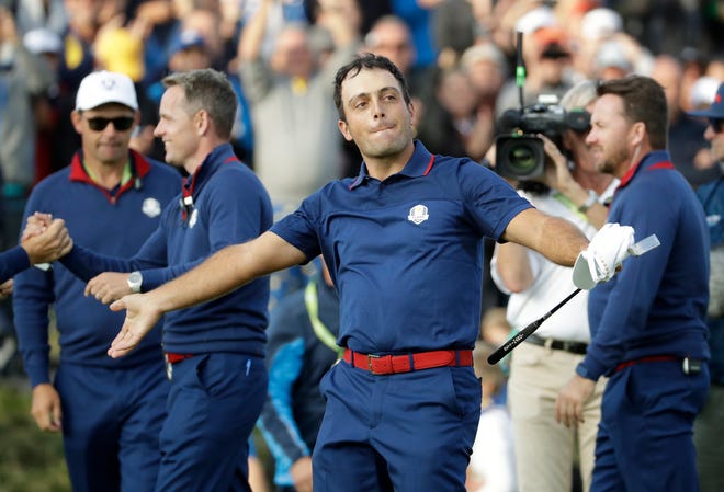 Europe's Francesco Molinari celebrates after winning a foursome match with his partner Tommy Fleetwood on the opening day of the 42nd Ryder Cup at Le Golf National in Saint-Quentin-en-Yvelines. [AP Photo/Matt Dunham]