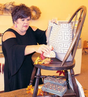 New business owner Danielle Salz prepares a seasonal display. Salz buys items from local crafters in an effort to inspire people like herself to pursue their passion.