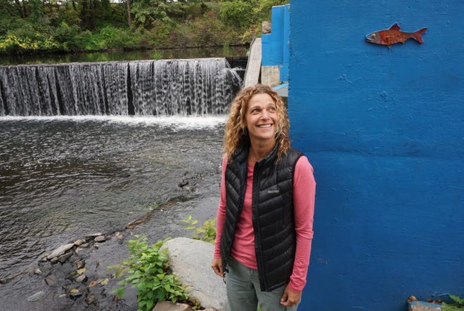 Lisa Aurecchia, standing near the Atlantic Mills Fish Ladder at the Atlantic Mills Dam, is the director of projects for the nonprofit Woonasquatucket River Watershed Council. [The Providence Journal / Sandor Bodo]