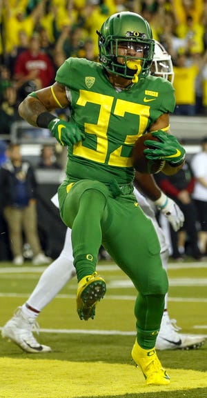 Oregon running back Cyrus Habibi-Likio celebrates his touchdown against Stanford in last week's game. [Andy Nelson/The Register-Guard]