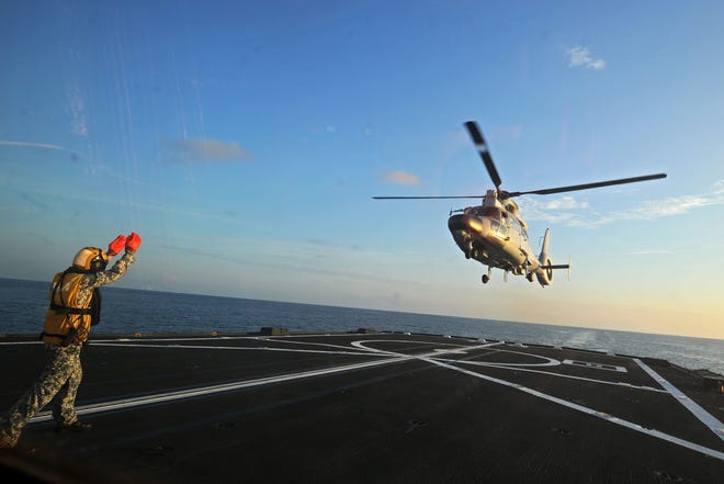 A Dolphin Z-9 helicopter from China’s Navy missile frigate CNS Yulin flies off the deck of Singapore’s Navy missile frigate RSS Intrepid during “Exercise Maritime Cooperation 2015” held in the South China Sea on May 25, 2015, near Singapore. [Then Chih Wey/Xinhua/Sipa USA file via TNS]
