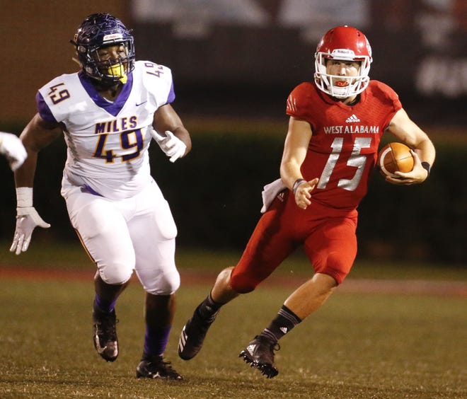 West Alabama quarterback Harry Satterwhite scrambles away from pressure from Miles College defensive lineman Kadarius Roberts on Thursday, Sept. 6, 2018. [Staff Photo/Gary Cosby Jr.]