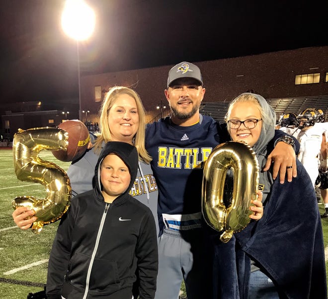 Battle head coach Justin Conyers, center, poses with his family after winning his 50th game as a head coach. The win was also the Spartans’ 50th win in program history. Battle defeated Hickman 37-20 [Submitted photo]
