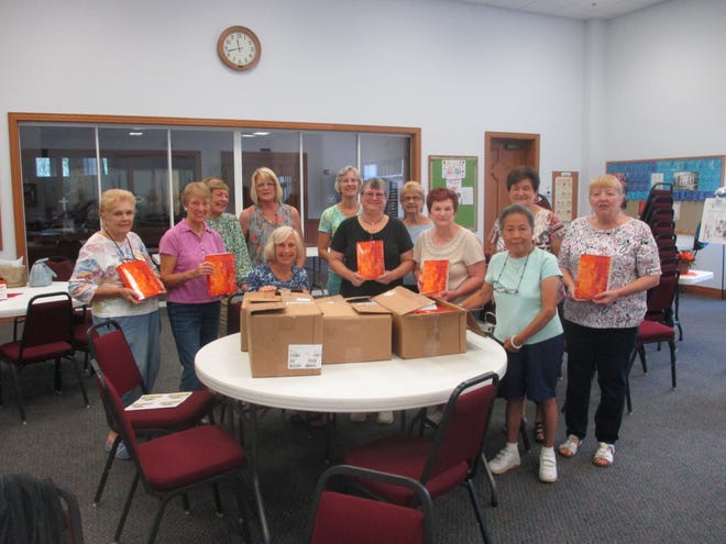 Members of Beautiful Savior Lutheran Church's morning Bible study group recently gathered to insert gift labels in new, free, paperback Bibles distributed to various hospitals and other agencies in Sarasota and Manatee Counties. [PROVIDED PHOTO]