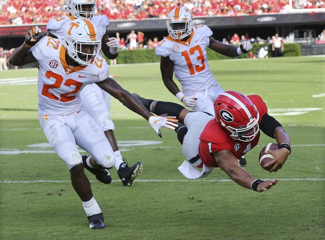 Georgia quarterback Justin Fields dives into the end zone past Tennessee defensive back Micah Abernathy Saturday in Athens, Ga. [Curtis Compton/Atlanta Journal Constitution via AP]