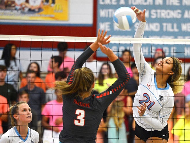 Southside's Aleigha Johnson, right, hits over Cabot's Ashlee Wilkerson during the second set on Tuesday, Sept. 4, 2018, at Southside. Southside won the match 3-0. [BRIAN D. SANDERFORD/TIMES RECORD]