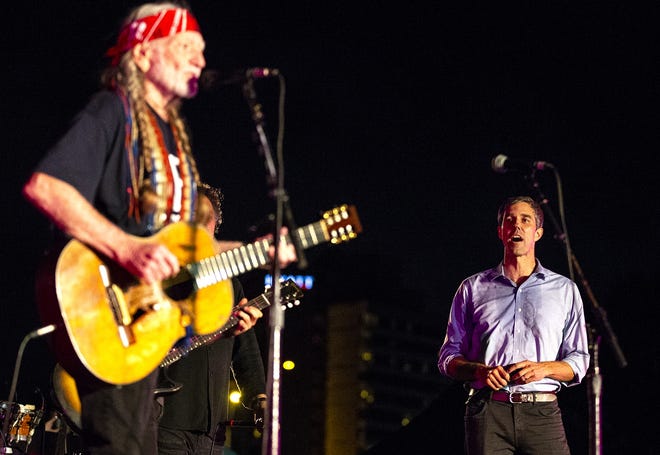 U.S. Rep. Beto O'Rourke sings "I've Been Everywhere" with Willie Nelson before an estimated 55,000 people at Auditorium Shores near downtown Austin on Saturday. [NICK WAGNER/AMERICAN-STATESMAN]
