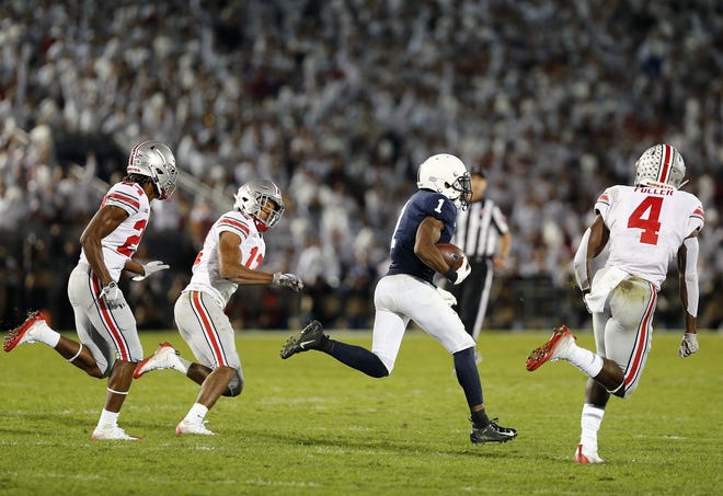 Penn State receiver KJ Hamler splits Ohio State safeties Isaiah Pryor, center, and Jordan Fuller on his way to the end zone for a 93-yard touchdown reception. [Kyle Robertson/Dispatch]