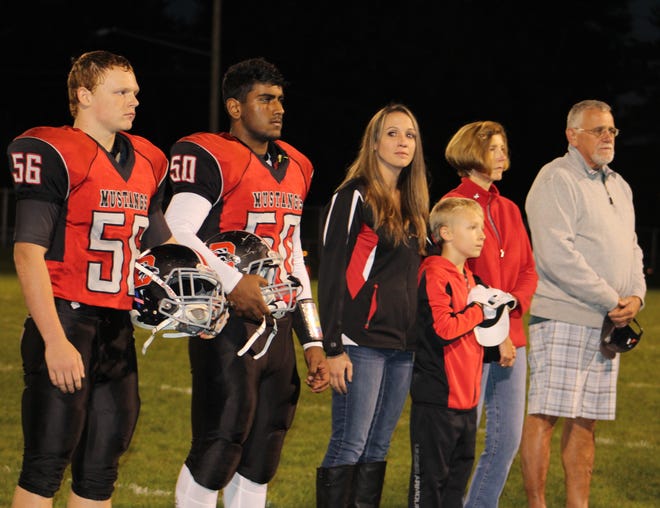The Button family with Lynne, Matthew, Paul and Tina. The Dansville Mustangs honored Kyle on Homecoming.