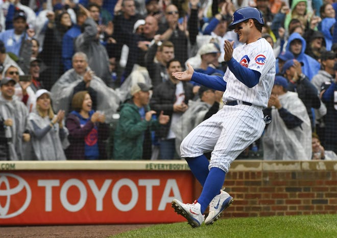 Chicago Cubs' Anthony Rizzo (44) claps after he scored during the third inning of a baseball game against the St. Louis Cardinals on Sunday, Sept. 30, 2018, in Chicago. (AP Photo/Matt Marton)